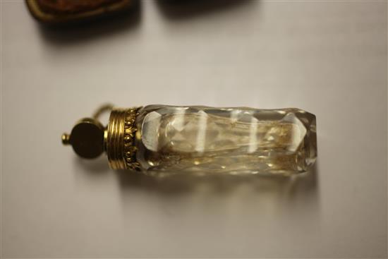 A cased late 18th century gold mounted cut glass miniature scent bottle with stopper and safety chain, approx. 2in.